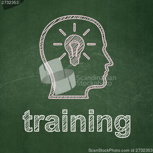 Image of Education concept: Head With Lightbulb and Training on chalkboard background