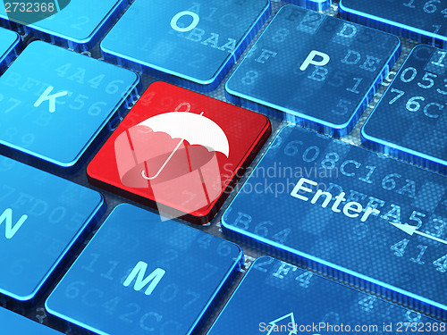 Image of Security concept: Umbrella on computer keyboard background