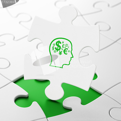 Image of Advertising concept: Head With Finance Symbol on puzzle background