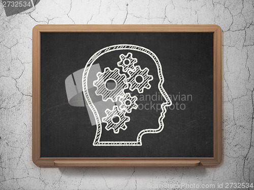 Image of Information concept: Head With Gears on chalkboard background