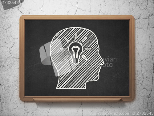 Image of Education concept: Head With Light Bulb on chalkboard background