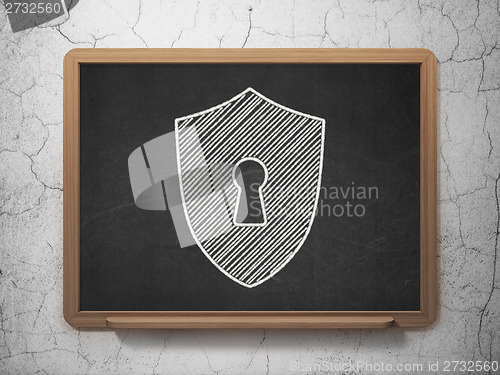 Image of Protection concept: Shield With Keyhole on chalkboard background