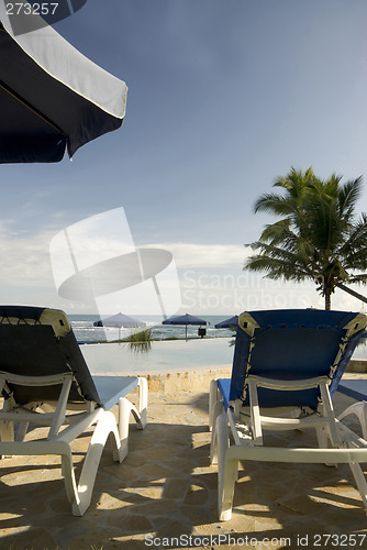 Image of chaise lounge chairs infinity pool