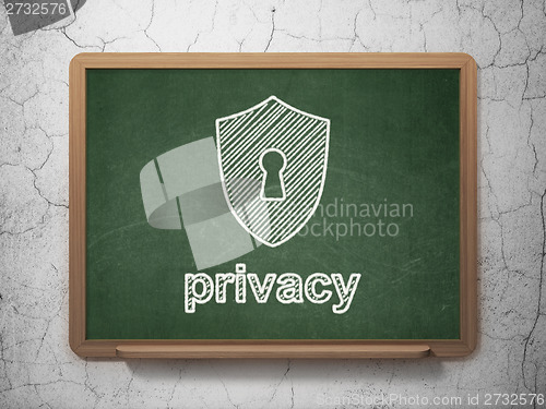Image of Privacy concept: Shield With Keyhole and Privacy on chalkboard background