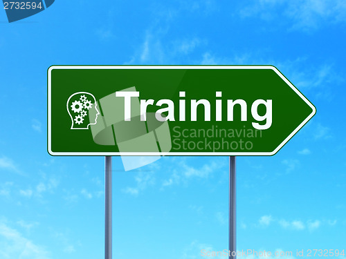 Image of Education concept: Training and Head With Gears on road sign background