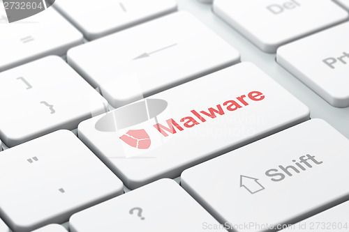 Image of Protection concept: Broken Shield and Malware on computer keyboard background