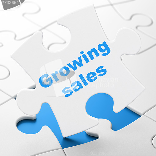 Image of Business concept: Growing Sales on puzzle background