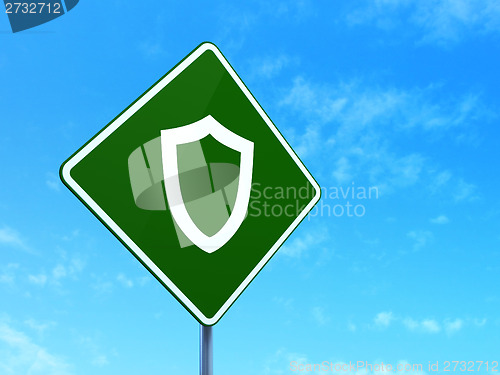 Image of Safety concept: Contoured Shield on road sign background