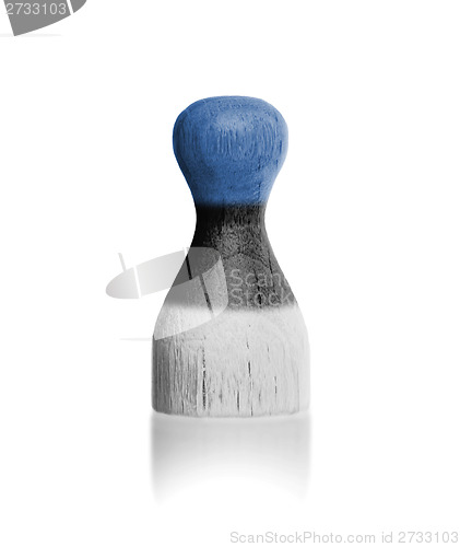 Image of Wooden pawn with a painting of a flag