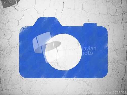 Image of Tourism concept: Photo Camera on wall background