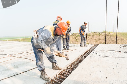 Image of Workers mount bridge span.