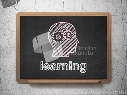 Image of Education concept: Head With Gears and Learning on chalkboard