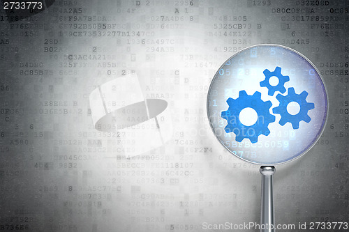 Image of Marketing concept:  Gears with optical glass on digital background