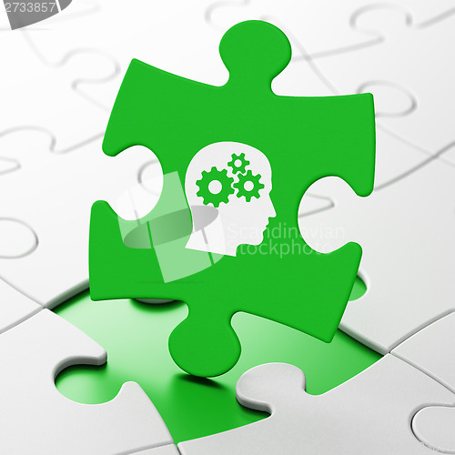 Image of Marketing concept: Head With Gears on puzzle background