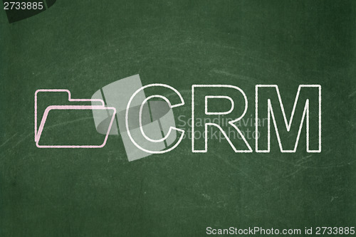 Image of Finance concept: Folder and CRM on chalkboard background