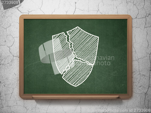 Image of Safety concept: Broken Shield on chalkboard background