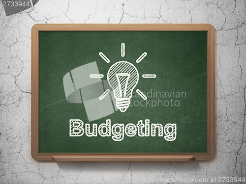 Image of Business concept: Light Bulb and Budgeting on chalkboard