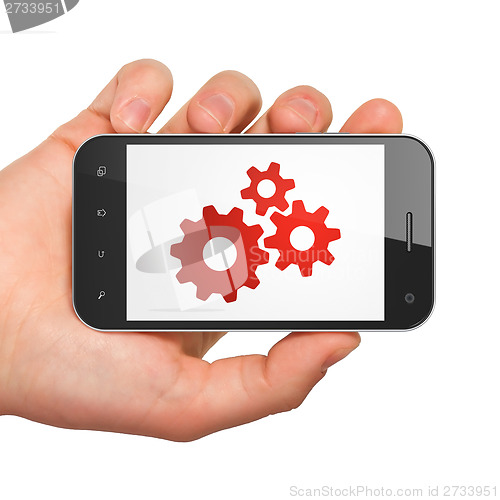 Image of Data concept: Gears on smartphone