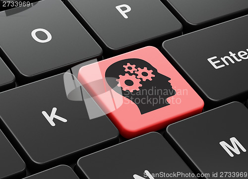 Image of Advertising concept: Head With Gears on keyboard background