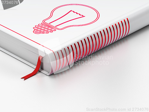 Image of Finance concept: closed book, Light Bulb on white background