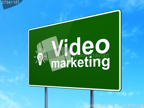 Image of Finance concept: Video Marketing and Light Bulb on road sign background