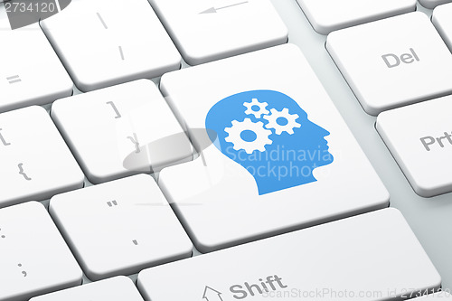 Image of Education concept: Head With Gears on keyboard background