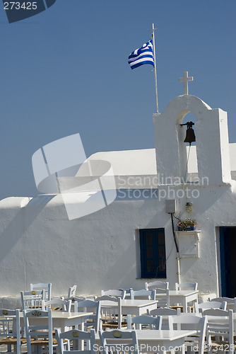 Image of greek island church and bells with flag