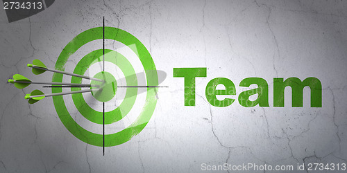 Image of Business concept: target and Team on wall background