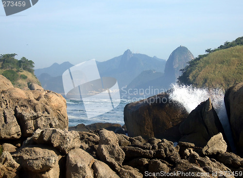 Image of Rocks on the beach, with Christ Redeemer statue, one of the new seven wonders of the world, in the background