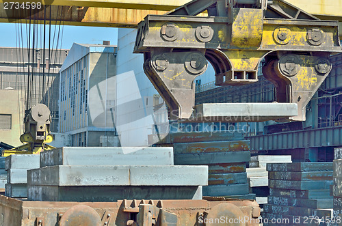 Image of Crane loading sheet steel