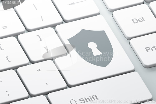 Image of Protection concept: Shield With Keyhole on keyboard background