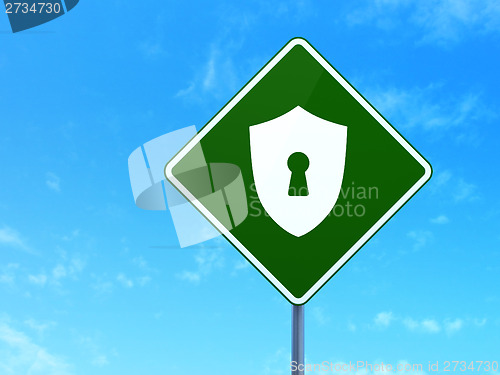 Image of Privacy concept: Shield With Keyhole on road sign background