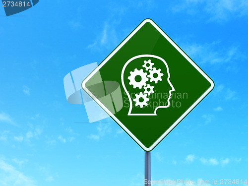 Image of Education concept: Head With Gears on road sign background
