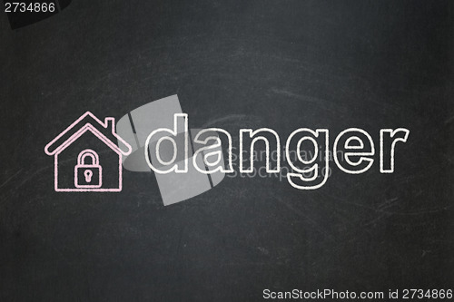 Image of Protection concept: Home and Danger on chalkboard background