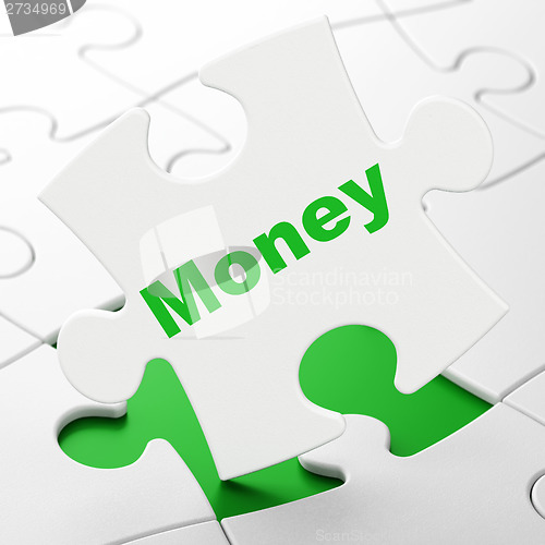 Image of Finance concept: Money on puzzle background