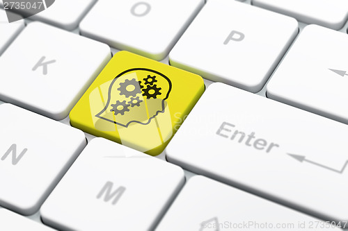 Image of Finance concept: Head With Gears on computer keyboard background