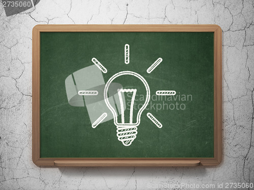 Image of Finance concept: Light Bulb on chalkboard background