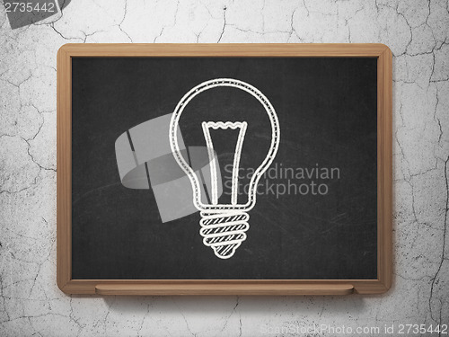 Image of Business concept: Light Bulb on chalkboard background