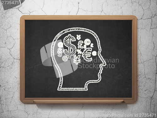 Image of Education concept: Head With Finance Symbol on chalkboard