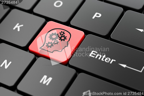 Image of Finance concept: Head With Gears on computer keyboard background