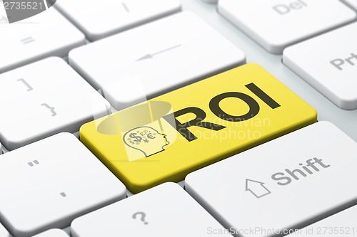 Image of Business concept: Head With Finance Symbol and ROI on keyboard