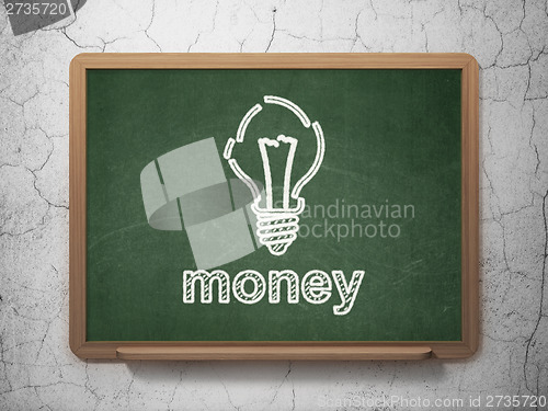Image of Business concept: Light Bulb and Money on chalkboard background