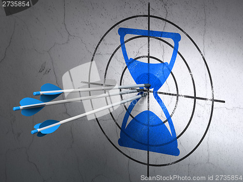 Image of Timeline concept: arrows in Hourglass target on wall background