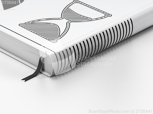 Image of Timeline concept: closed book, Hourglass on white background