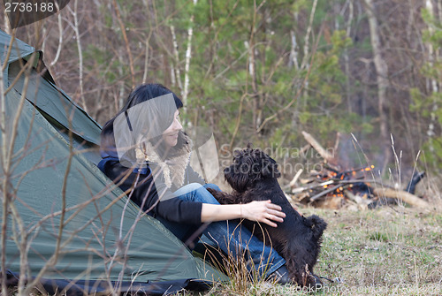 Image of Woman with a dog camping