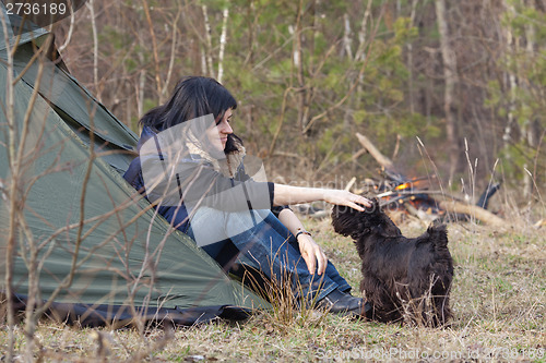 Image of Woman with a dog camping