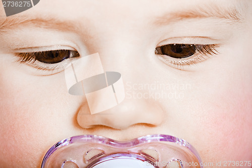 Image of face baby with pacifier closeup. macro