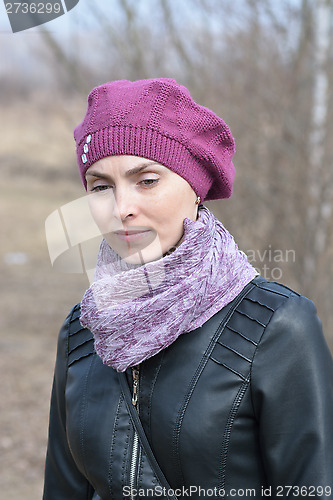 Image of Woman in pink beret and black leather jacket on a walk