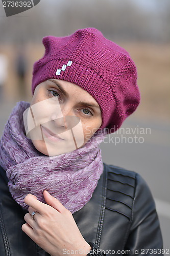 Image of Woman in pink beret and black leather jacket on a walk