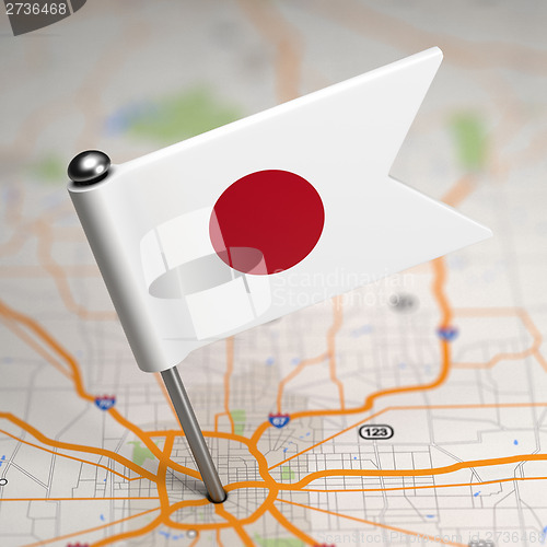 Image of Japan Small Flag on a Map Background.